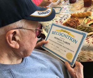 Memory care resident at Angels for the Elderly holding certificate in Montgomery, AL