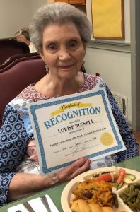 Angels for the Elderly memory care resident holding certificate in Montgomery, AL