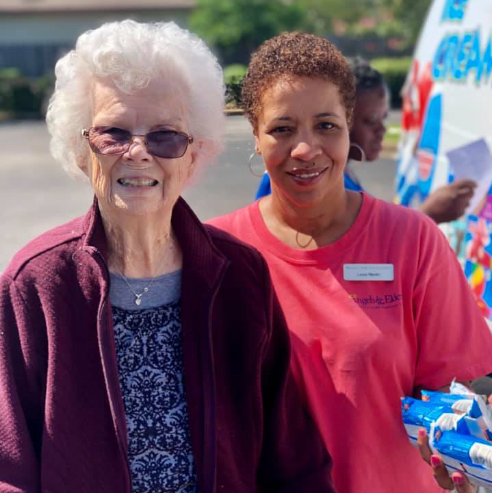 Angels for the Elderly resident and associate outside with ice cream in Montgomery, AL