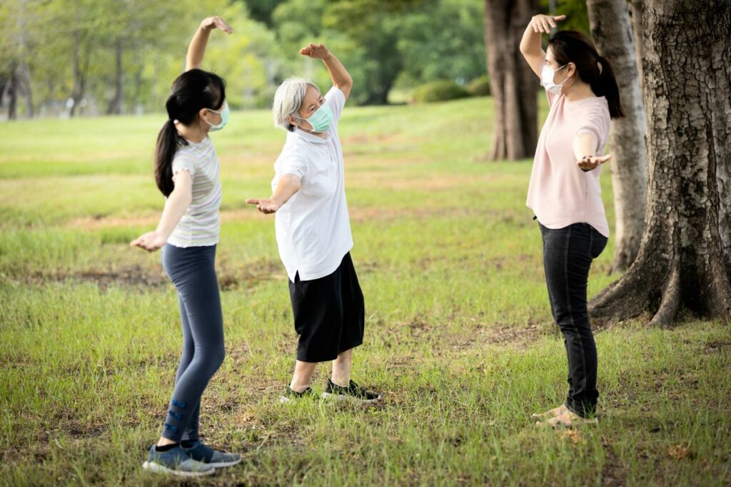 Lake Howard Heights | Senior woman exercising outdoors with young women