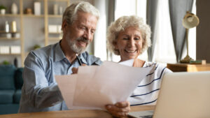 Lake Howard Heights | Seniors smiling with paperwork