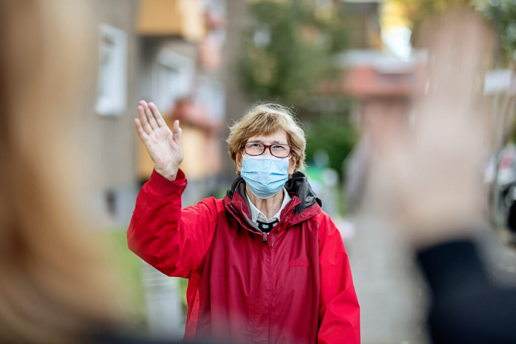 Lake Howard Heights | Senior woman waving in mask