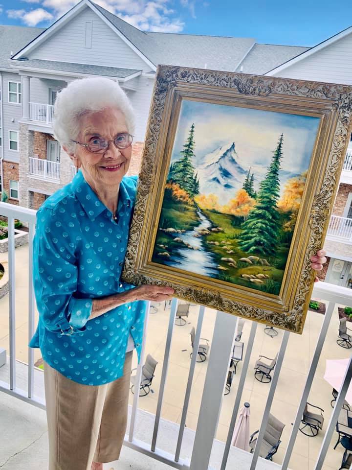 Legacy Reserve at Fritz Farm | Resident with painting from art contest