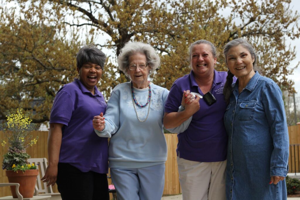 Legacy Reserve at Old Town | Senior with caregivers outdoors