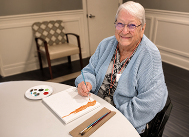 Senior doing painting canvas