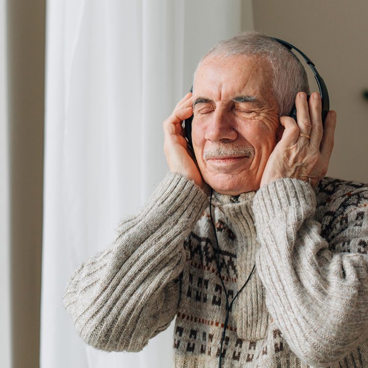 Legacy Ridge at Brookstone | Senior man listening music in headphones