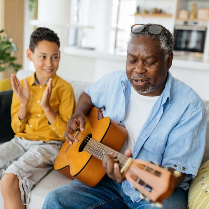 Legacy Ridge at Bookstone | Grandfather playing guitar for his grandson