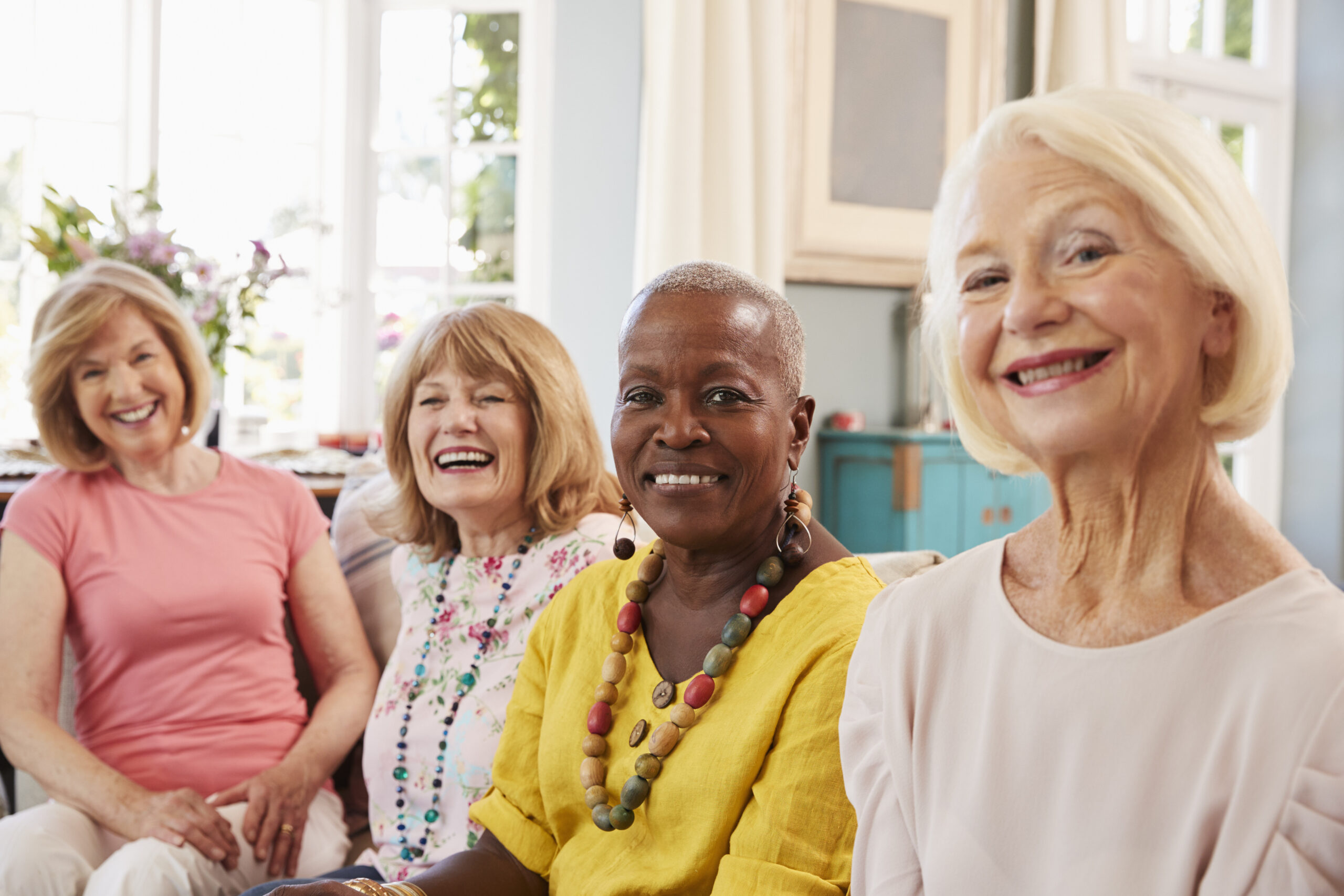 Legacy Ridge at Buckhead | Portrait Of Senior Female Friends Relaxing On Sofa At Home