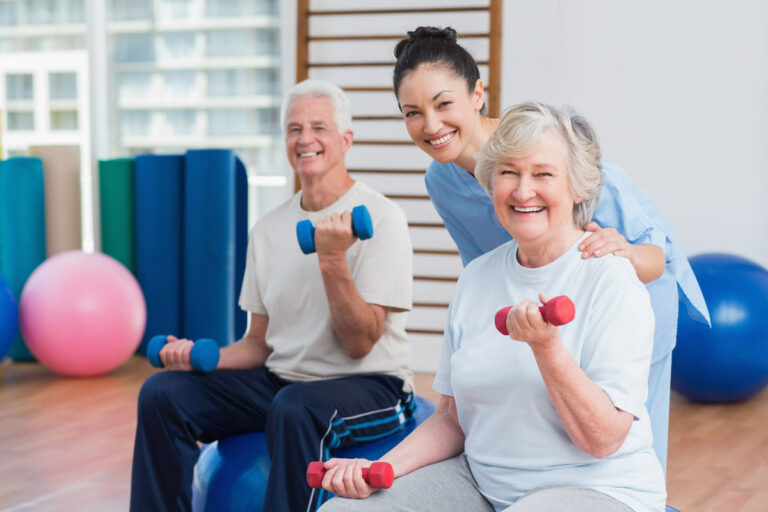 Legacy Ridge at Sandy Plains | Seniors exercising with guidance of caregiver
