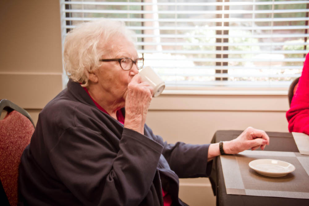 Legacy Ridge at Trussville | Resident drinking out of a mug