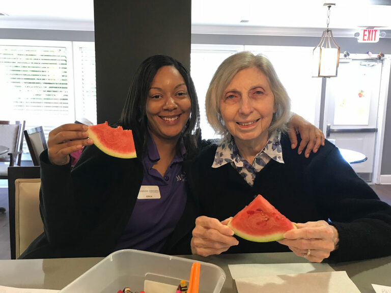 Madison Heights Evans | Resident and associate eating watermelon