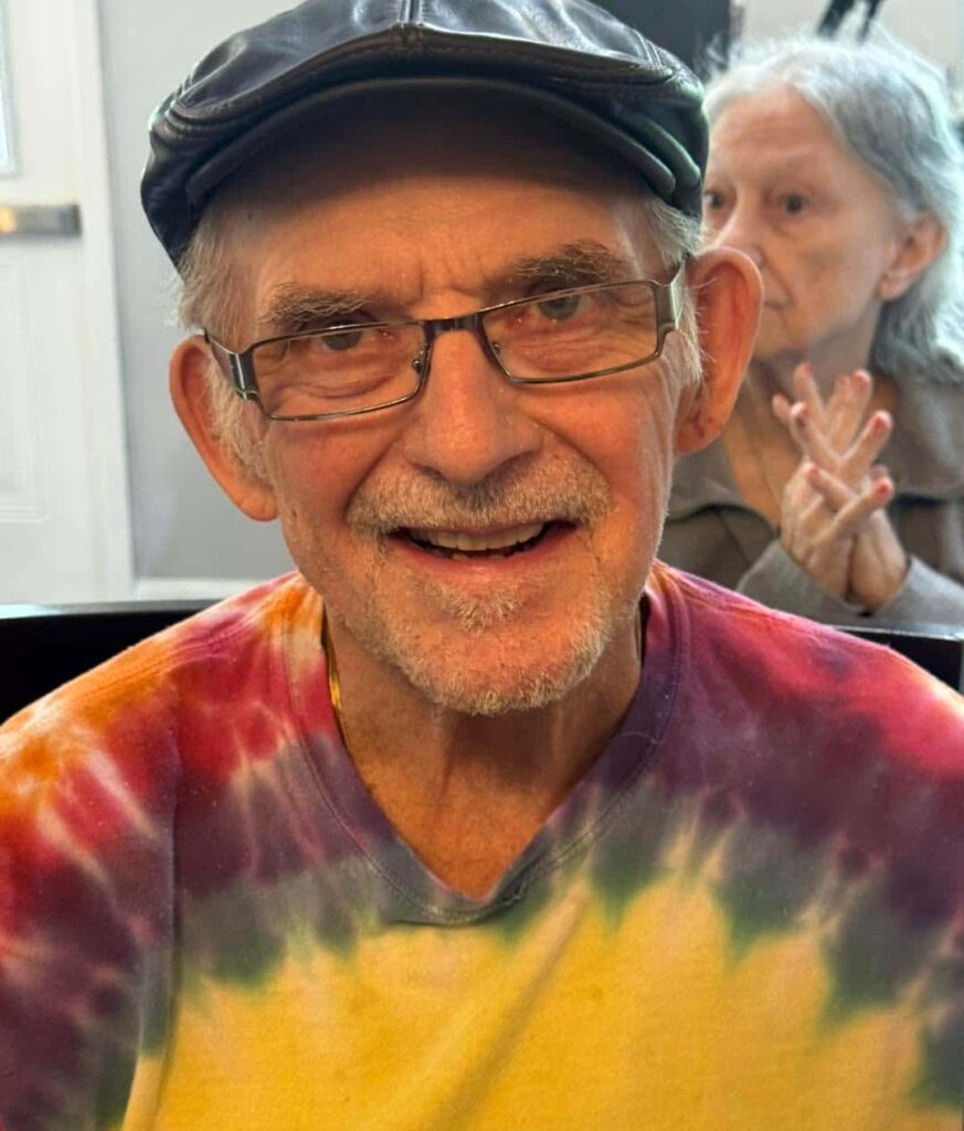 Resident smiling during a community activity at Madison Heights at Evans, a specialized Memory Care community in Evans, GA.