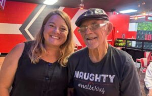 Resident enjoying a social outing with a companion from Madison Heights at Evans, a Memory Care community in Evans, GA.