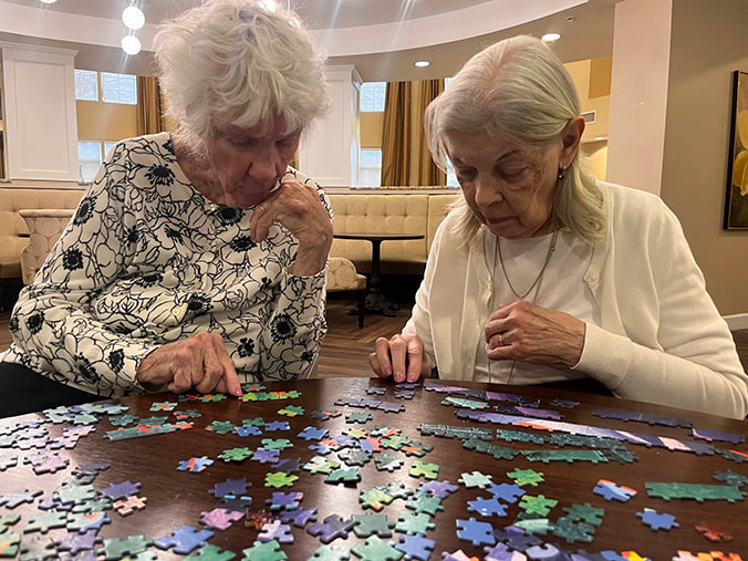 Senior Ladies Playing Jigsaw in a Senior Living Community