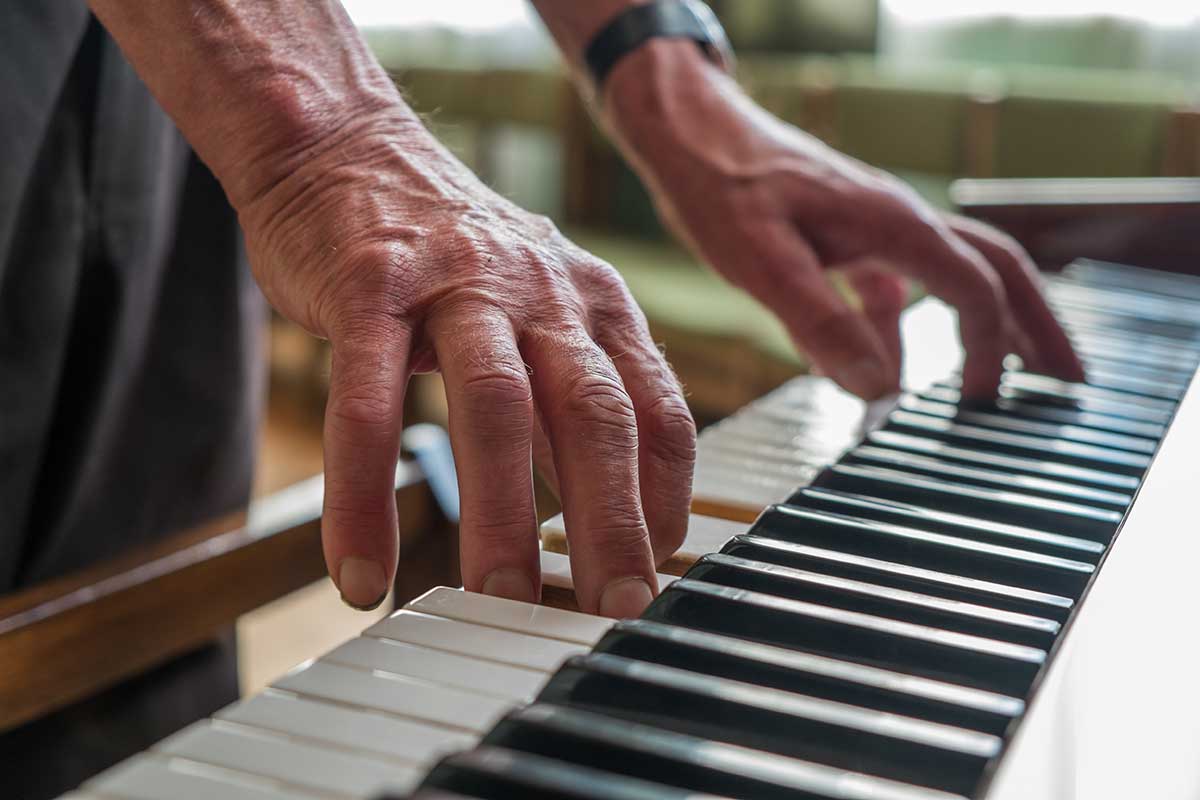 The Goldton at Southaven | Senior man playing piano