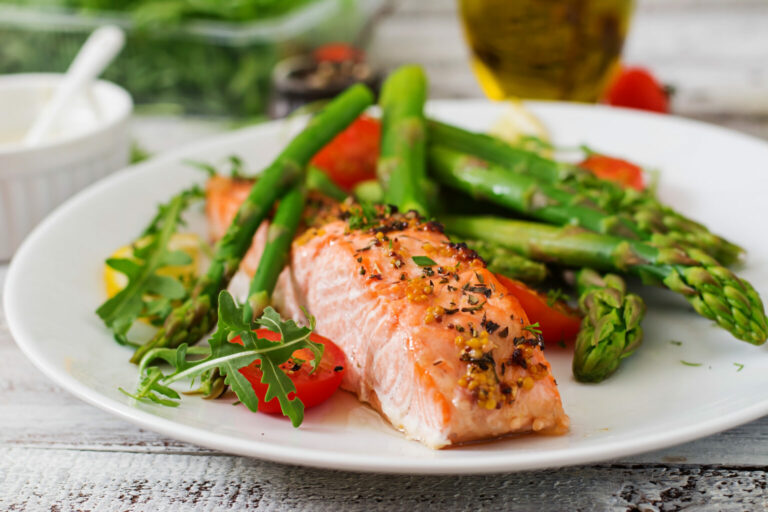 The Goldton at Southaven | Baked salmon garnished with asparagus and tomatoes with herbs