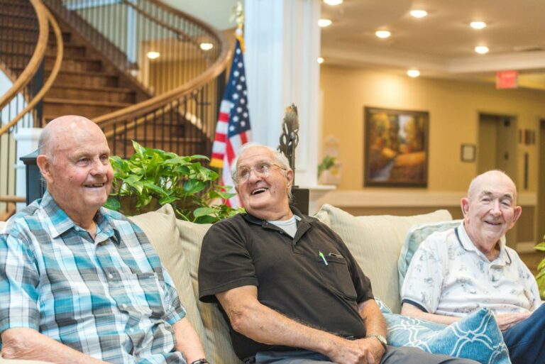 The Goldton at Spring Hill | Senior men laughing on couch