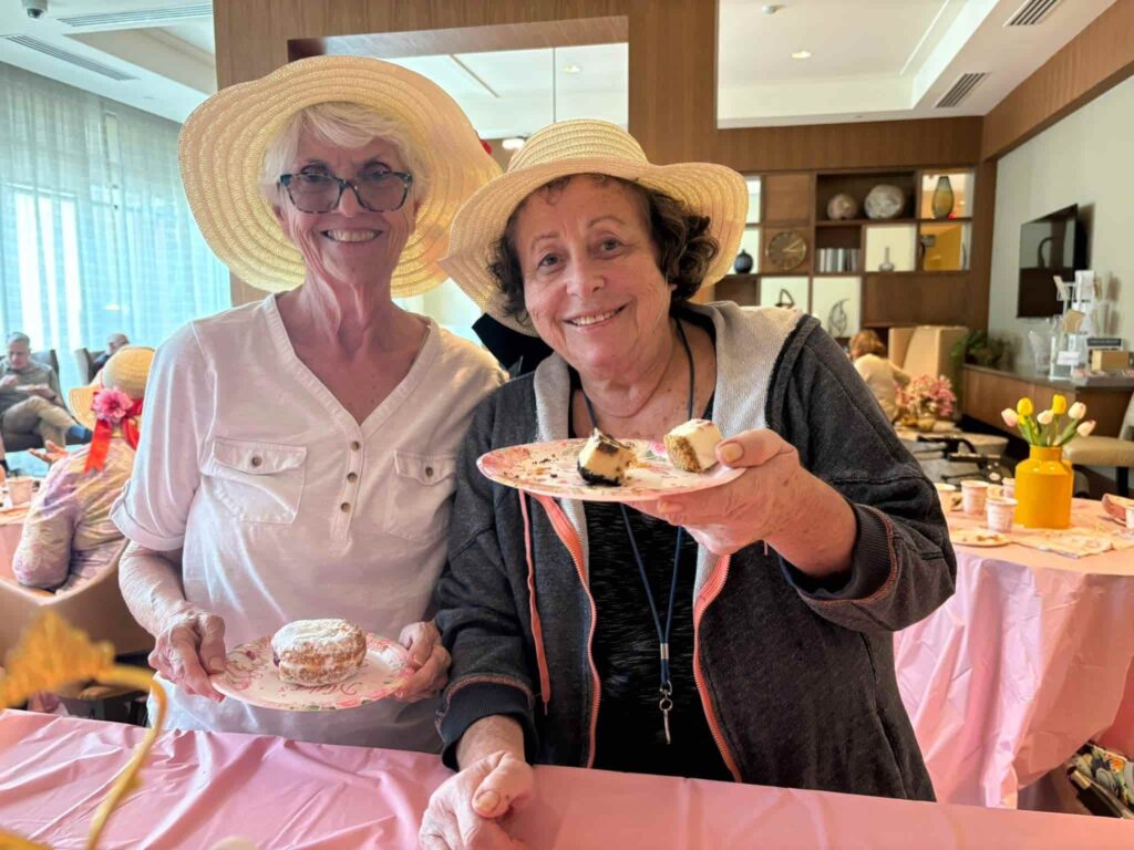 Two residents at Tribute at Black Hill enjoying a social activity together in Germantown, MD