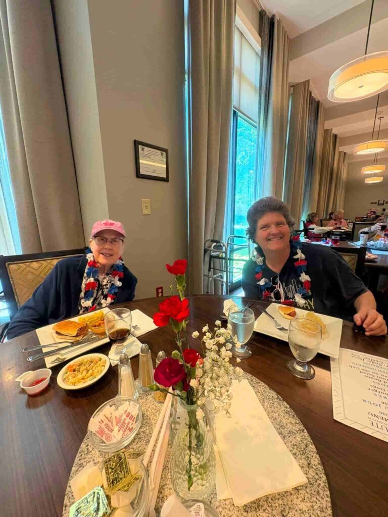 Senior resident enjoying a meal and social time at an Assisted Living community in Ashburn, Virginia