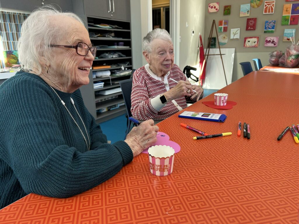 Residents at Tribute at Glen in Woodbridge, VA, enjoying creative activities and social connection in a group setting.