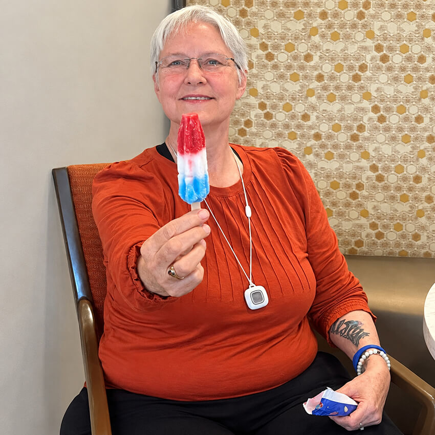Senior Woman Enjoying a Patriotic Popsicle