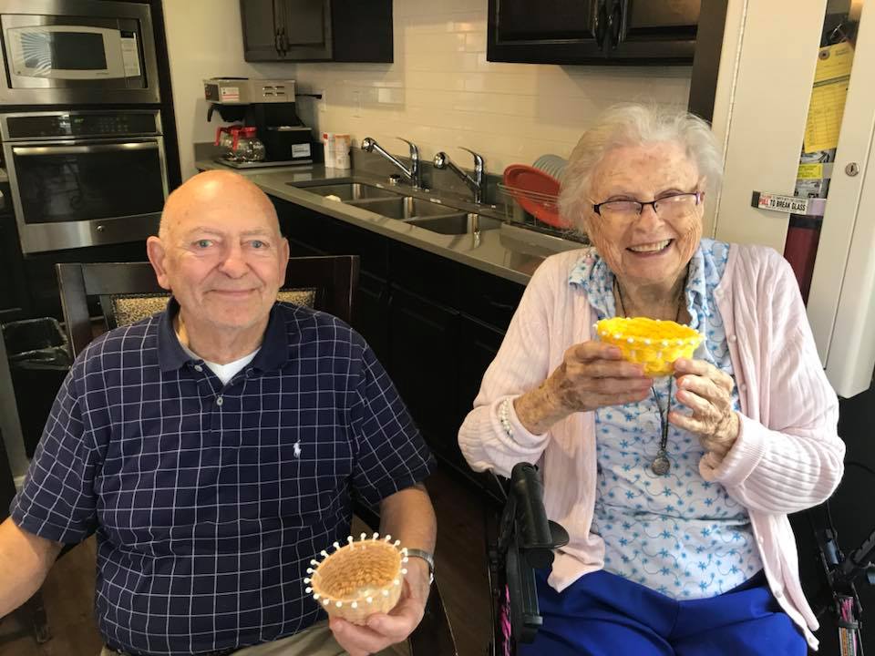 Madison Heights | Smiling seniors holding crafts