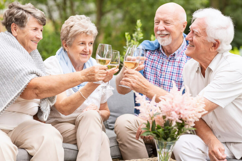 Atlas Senior Living | Seniors having wine on the patio