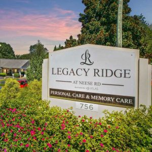 Atlas Senior Living | Outdoor sign for Legacy Ridge at Neese Rd at Sunset